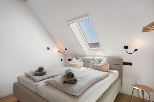 a bedroom with a bed with white sheets and a window at Ferienwohnungen Stolzenhagener 7 in Lunow