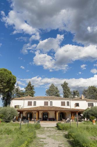 a large white building with trees in the background at Agriturismo B&B La Sterpina in SantʼArcangelo