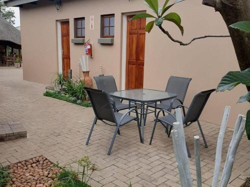 a table and chairs sitting on a patio at Wi Villa Lê Guest House in Fichardtpark