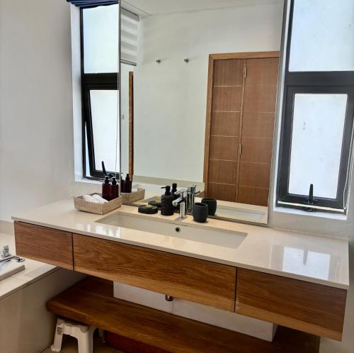 a bathroom with a sink and a mirror at Luxury Apartment on the Beach in Belle Mare