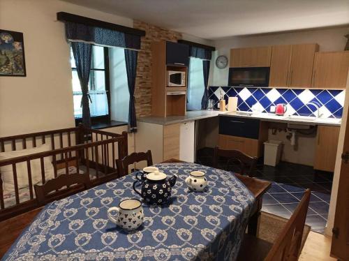 a kitchen with a table with two tea pots on it at Chalupa pro 2 rodiny in Kněževes