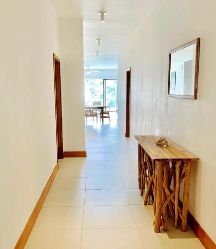 a hallway with a table and a dining room at Luxury Apartment on the Beach in Belle Mare