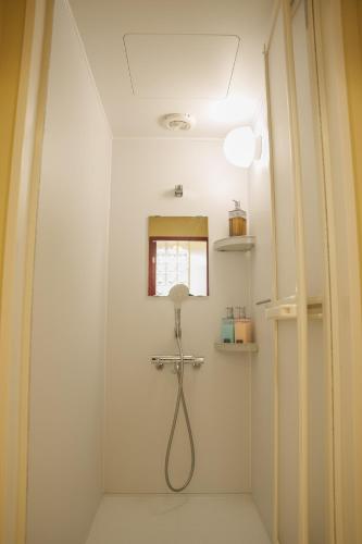 a bathroom with a shower with a shower head at 寅ホテル 御徒町 TORA HOTEL Okachimachi in Tokyo