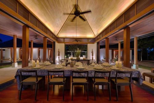 a dining room with a large table and chairs at Villa Ananda at Jivana Beach Villas in Pilai Beach