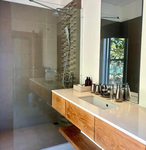 a bathroom with a sink and a mirror at Luxury Apartment on the Beach in Belle Mare