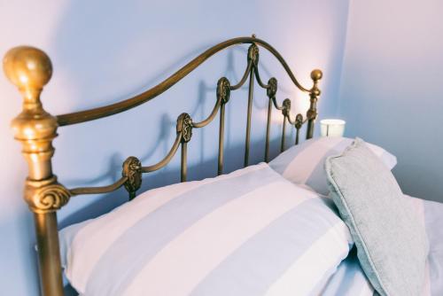 a wooden bed with white pillows on it at 1 Bed Sleeps 2 Free Parking Pets Welcome in East Dereham