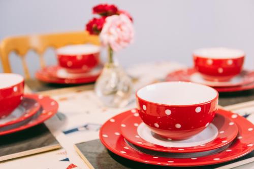 three red cups and saucers on a table at 1 Bed Sleeps 2 Free Parking Pets Welcome in East Dereham