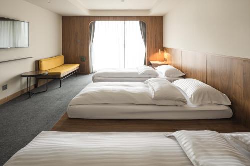 Postel nebo postele na pokoji v ubytování 天下南隅 Provintia Hotel