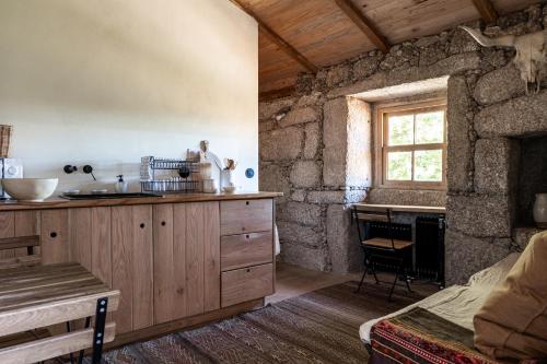 a kitchen with a sink and a counter with a window at Levada da Breca - Turismo Rural in Ervedeiros