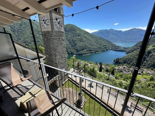 a balcony of a house with a view of a lake at Bright studio with panoramic view of Valle Verzasc in Mergoscia