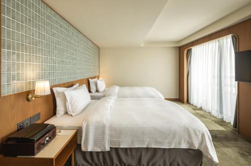Postel nebo postele na pokoji v ubytování 天下南隅 Provintia Hotel