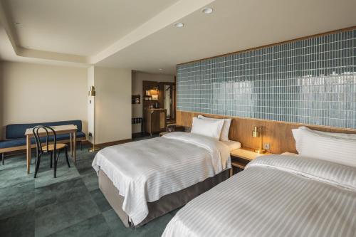 Postel nebo postele na pokoji v ubytování 天下南隅 Provintia Hotel