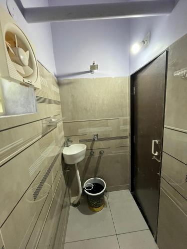 a small bathroom with a sink and a toilet at Sri Datta Kukkuteswara Nilayam in Pithāpuram
