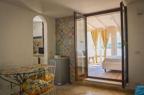 a room with a mirror and a bedroom with a bed at Il Mare a Roma - Attico Fronte Mare in Lido di Ostia