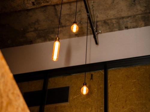 a group of lights hanging from a ceiling at eeGee STAY Kamata in Tokyo
