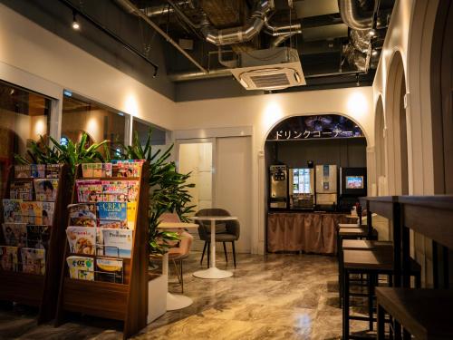 a room with a restaurant with a table and chairs at eeGee STAY Kamata in Tokyo