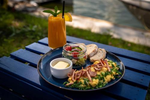 a blue table with a plate of food and a drink at Nautica Resort in Giżycko