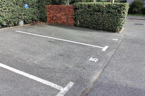 a parking lot with white lines on the ground at Appartement de 51 m2 avec jardin de 51 m2, parking privé in Achères