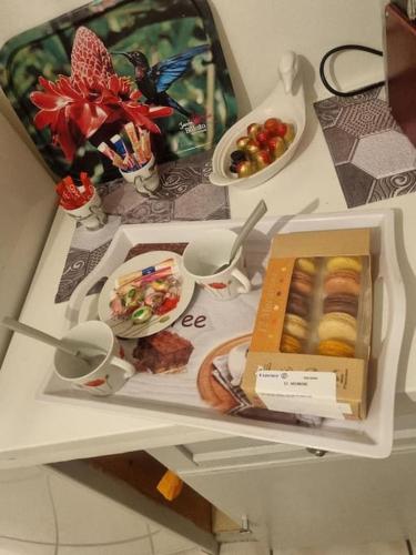 a table with a box of food on it at Appartement de 51 m2 avec jardin de 51 m2, parking privé in Achères