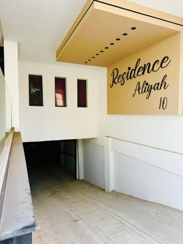 a building with a sign that reads resilience align at Fabuleux appartement vue sur mer Fibre IPTV Netflix in Mehdiya-Plage