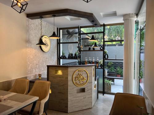 a restaurant with a bar with a table and chairs at Burj Ul Zaki in Islamabad