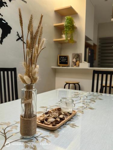a table with a vase with a plate of food at 28 Residence Homestay in Melaka