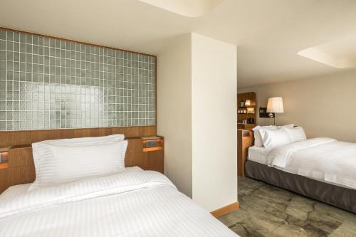 Postel nebo postele na pokoji v ubytování 天下南隅 Provintia Hotel