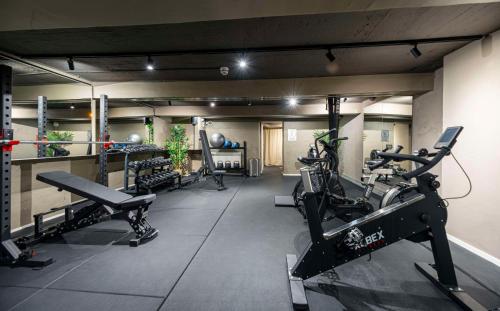 a gym with several treadmills and cardio machines at Best Western Hotel Karlaplan in Stockholm