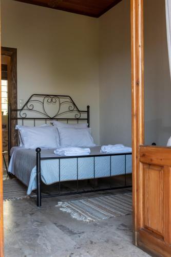 a bed with a metal frame in a bedroom at 1924 Studios 2 in Áyios Pétros