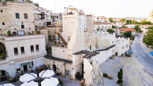 an aerial view of an old city with buildings at Tafoni Houses Cave Hotel in Ortahisar