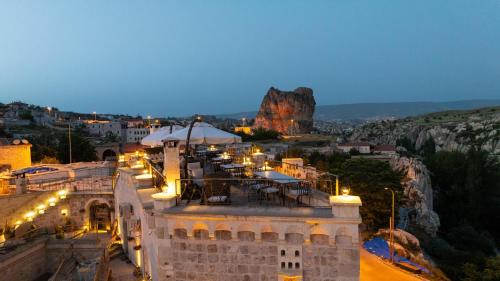 a view of a building with lights at night at Tafoni Houses Cave Hotel in Ortahisar