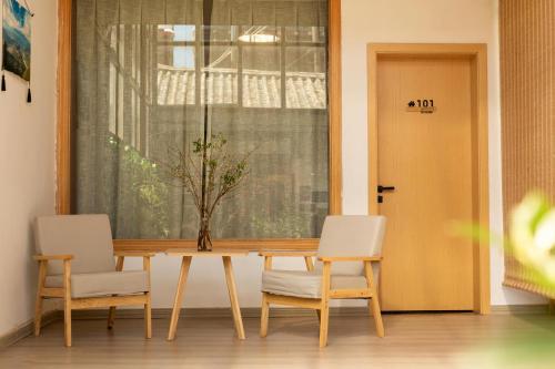 a dining room with a table and two chairs at 雪湖轻奢民宿 Snowlake Inn in Shangri-La