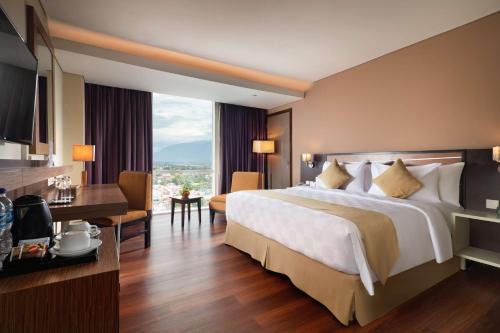 Postel nebo postele na pokoji v ubytování Best Western Plus Coco Palu