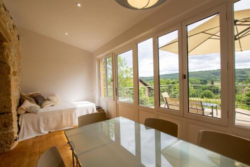 a bedroom with a bed and a glass table at L'Épicerie de Bezenac in Bézenac