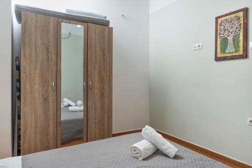 a bedroom with a mirror and a bed at Voula Apartment in Ermoupoli