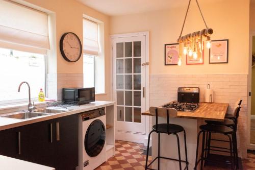 a kitchen with a sink and a counter with a stove at The Parade -Corner Plot Getaways in Redcar