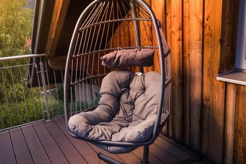 a bird cage sitting on a porch at Chalet Almblick in Fischbach