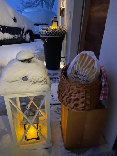 a street light and a lantern in the snow at Luxus Ferienwohnung Almhütte in Brixen im Thale