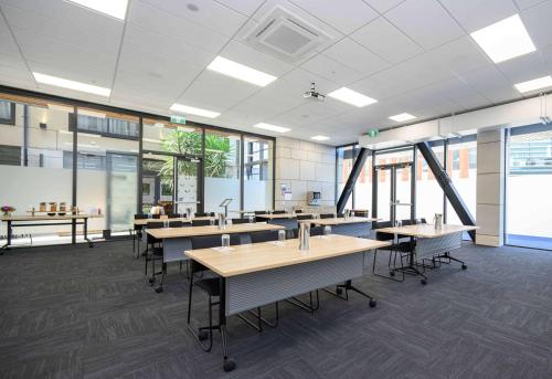 an office with tables and chairs and windows at Sudima Christchurch City in Christchurch