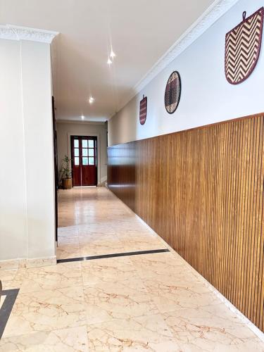 an empty hallway with a wall of wood at Akim Homestay in Kohīma