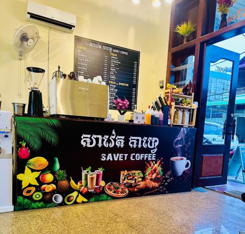 a sign for a save coffee shop with food on it at Savet Guesthouse in Stœ̆ng Trêng