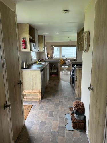 a kitchen with an open door leading into a room at Cookies Den in Weymouth