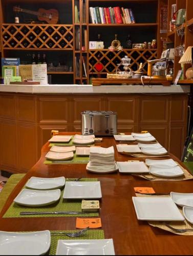 a table with plates and utensils on it at Edinburgh Hostel in Zhangjiajie