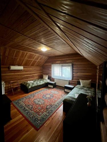 a large room with two beds and a rug at Комфорт in Polyana