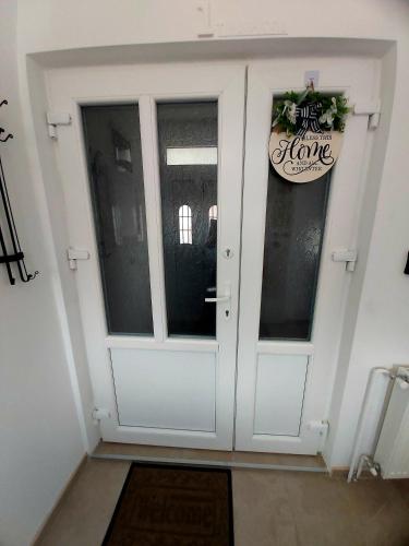 a white door with a sign on it at Tiha Voda 1 in Požarevac