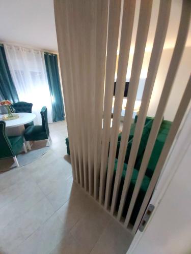 a staircase in a living room with a table and chairs at Tiha Voda 1 in Požarevac