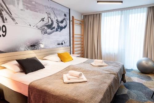 a hotel room with a bed with towels on it at Hotel Sport - Terme Krka in Otočec