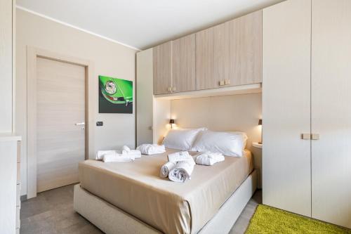 a bedroom with a large bed with white pillows at Palazzo Stupino - Il Duomo in Alba