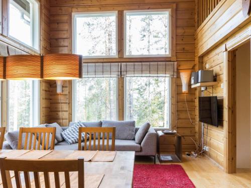 a living room with a couch and a table at Holiday Home Uuvana by Interhome in Äkäslompolo