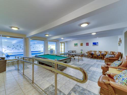 a room with a pool table and chairs at Holiday Home Borówna-1 by Interhome in Lipnica Górna